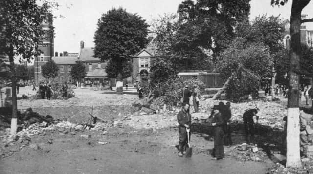 THEN 

The Royal Naval Barracks, Queen Street after  the raid of August 12, 1940. The Roman CatholiccCathedral can be seen behind the tree on the right.