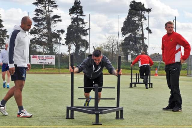 Event organiser, Leading Physical Trainer Peter Ozzy Oswald puts in one of the 1,274 lengths of the astro turf required to complete the distance to Twickeham Picture: LA (Phot) Dave Jenkins