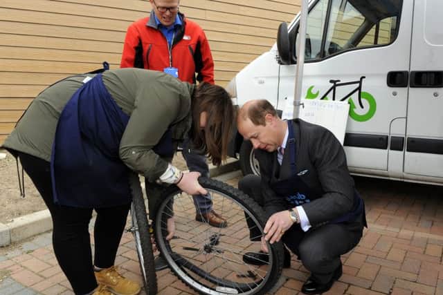 Prince Edward has a go at changing a tyre