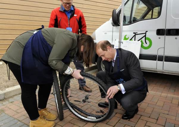Prince Edward has a go at changing a tyre