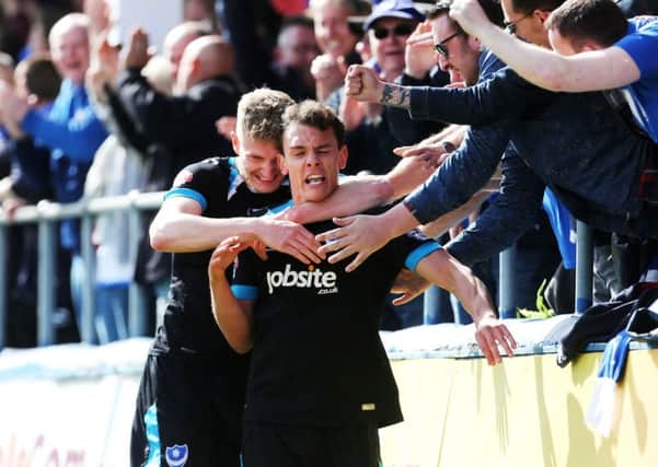 Kal Naismith celebrates with Michael Smith and the fans after opening the scoring for Pompey in the second half Picture: Joe Pepler