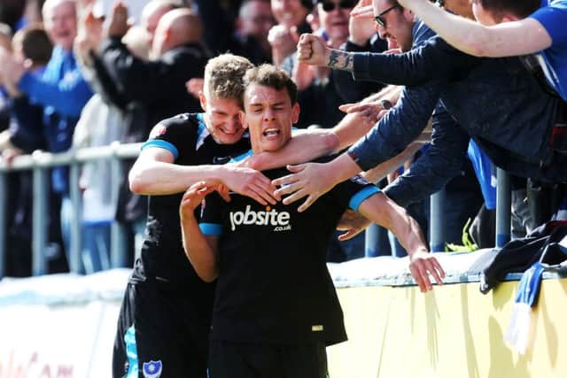 Kal Naismith celebrates with Michael Smith and the fans after opening the scoring for Pompey in the second half Picture: Joe Pepler