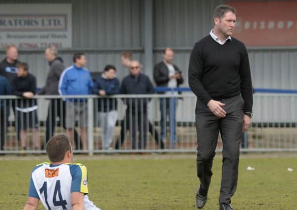 Hawks boss Lee Bradbury cuts a dejected figure after their National League South relegation   Picture: Mick Young