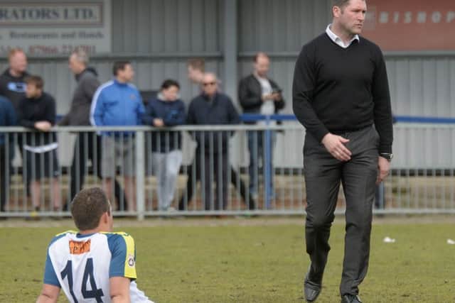 Manager Lee Bradbury and Scott Donnelly look dejected after the Hawks 1-1 draw with Weston-super-Mare confirmed their relegation from National League South Picture: Mick Young
