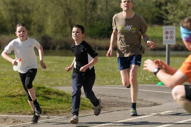 Antony Burr, from Waterlooville, running the parkrun with his children Harriet and Eddie. Picture: Mick Young (160485-05)