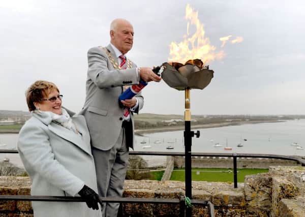 Anne and Mike Ford at the recent lighting of the Beacon on the keep at Portchester Castle in celebration of Her Majestys 90th birthday.

Picture: Sarah Standing (160634-4563)