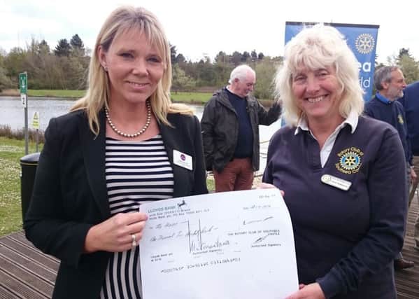 The Haven community fundraiser Heidi Rehman with Dragon Boat Festival organiser Carol Jenkinson with a cheque for Â£1,200 raised for The Haven at last year's boat race
