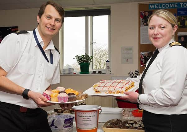 Lieutenant Jen Kedge and Able Rate Andy Hobby offering homemade treats in exchange for donations.

Photographer- Keith Woodland, Crown Copyright.