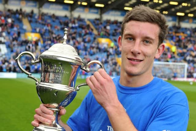 Jason Pearce lifts the coveted Pompey player of the year trophy for the 2011-12 season    Picture: Steve Reid
