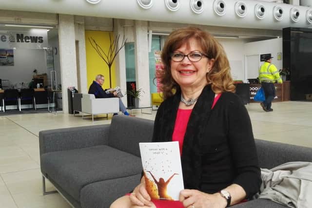 Author Elizabeth Caush with her second book, Cancer with a small c