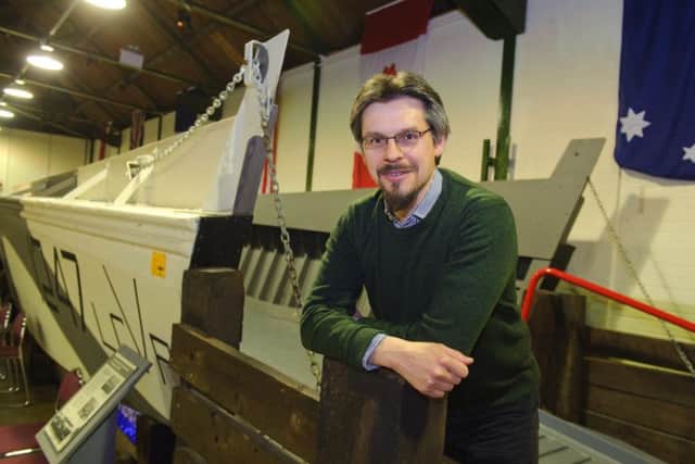 D-Day museum development officer Andrew Whitmarsh with a landing craft