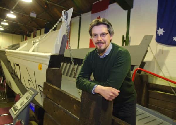 D-Day museum development officer Andrew Whitmarsh with a landing craft