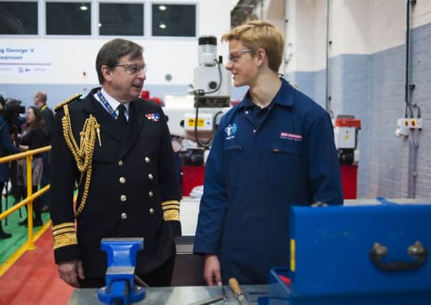 Vice Admiral Jonathan Woodcock, OBE, Royal Navy, chats with one of BAE Systems apprentices during a tour of the refurbished Skills Development Centre in Portsmouth Naval Base Picture: BAE Systems