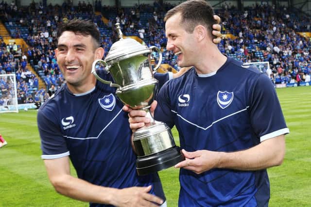 Gary Roberts, left, congratulates Michael Doyle on his The News & Sports Mail player of the year trophy. Picture: Joe Pepler