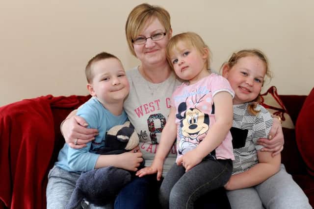 Charlie Harris (6) with his mum Marie Harris (41) and sisters Millie Harris (3) and Sofie Harris (8).
Picture: Sarah Standing (160652-5320)