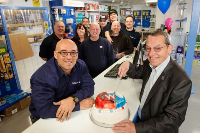 Branch manager Derran Gates, left, and founder of Williams & Co Mick Williams, cut a cake to celebrate the move into their new flagship store Picture: Allan Hutchings (160413-051)