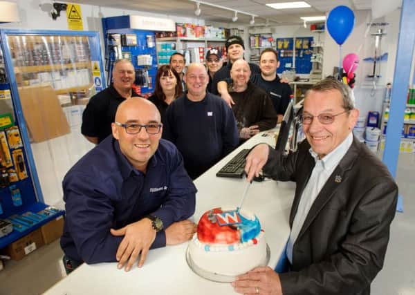 Branch manager Derran Gates, left, and founder of Williams & Co Mick Williams, cut a cake to celebrate the move into their new flagship store Picture: Allan Hutchings (160413-051)