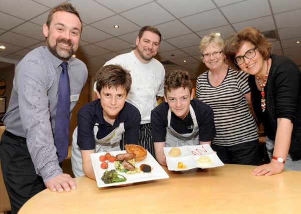 Winners Ryan Bloxsom, 13, and Scott Newell, 13, from Bay House School in Gosport with the judges, from left, business manager at the Wickham Co-operative Stuart Heaton, chef at The Marwell Hotel Phil Yeoman, home economist Davina Tibbetts, and organiser of The Create & Cook competition Min Raisman 
Picture: Sarah Standing (160669-7440)