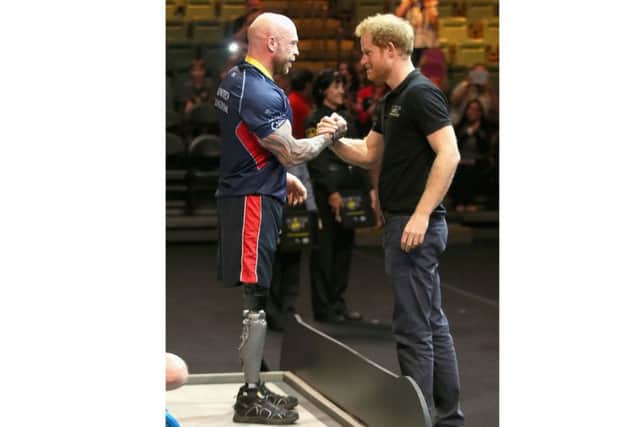 Prince Harry presents Micky Yule with the Powerlift Gold during the Invictus Games in Orlando Picture: Chris Jackson/PA Wire