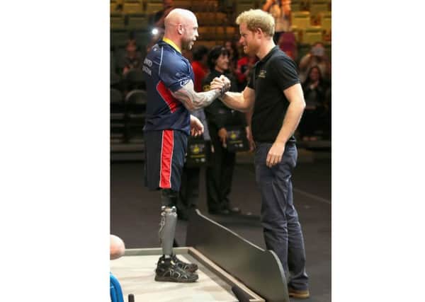 Prince Harry presents Micky Yule with the Powerlift Gold during the Invictus Games in Orlando Picture: Chris Jackson/PA Wire