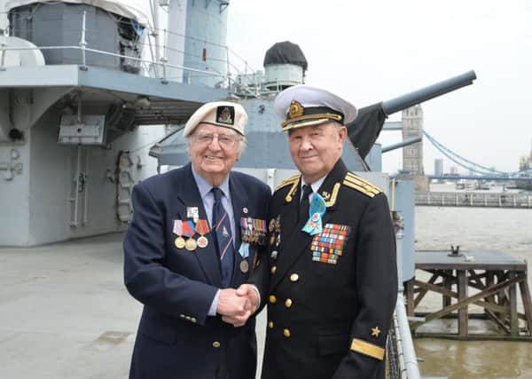 Baden Hall, 90, formerly of the Royal Navy with Russian Navy Captain Eduard Faizov (right), 89, during a commemorative service by British and Russian Second World War veterans to mark the 75th anniversary of the Nazi invasion of the Soviet Union and the first Arctic Convoy, onboard HMS Belfast in London. 
Picture: John Stillwell/PA Wire