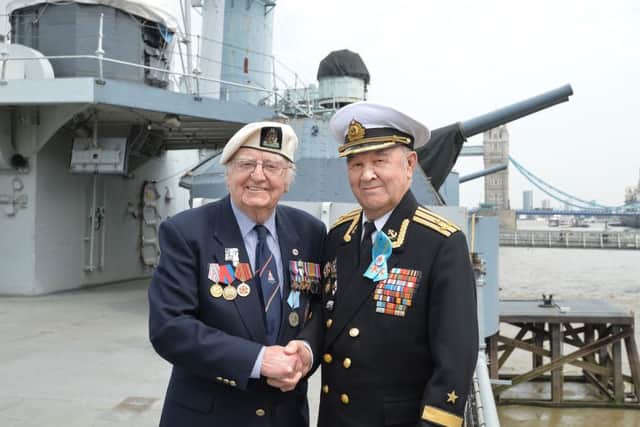 Baden Hall, 90, formerly of the Royal Navy with Russian Navy Captain Eduard Faizov (right), 89, during a commemorative service by British and Russian Second World War veterans to mark the 75th anniversary of the Nazi invasion of the Soviet Union and the first Arctic Convoy, onboard HMS Belfast in London. 
Picture: John Stillwell/PA Wire