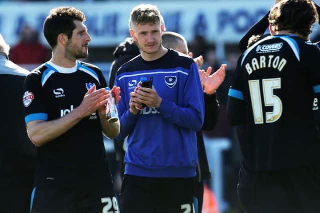 Michael Smith, centre, applauds the Pompey fans who travelled to Hartlepool on his last day at the club