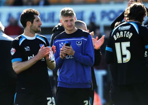Michael Smith, centre, applauds the Pompey fans who travelled to Hartlepool on his last day at the club