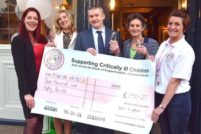Assistant manager Kelly Kelly, Kasia May, manager Dave Brown, Portsmouth South MP Flick Drummond, and Robyn Sargeant, trustee at the Friends of PICU which was presented with a Â£250 cheque at the reopening of The Dolphin in Old Portsmouth