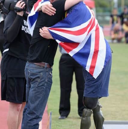 Prince Harry presents former Army captain David Henson with a gold medal for Team UK at the Invictus Games Picture: Chris Jackson/PA