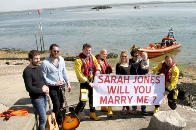 From left, Barry Hardman, Lewis Wright, Harrison Finch from the RNLI, Katie Baker from the RNLI, Sarah Jones with Mark Hummerstone and Shelby, two, Luke Rayner from the RNLI, and holding the boat, Gareth Davies