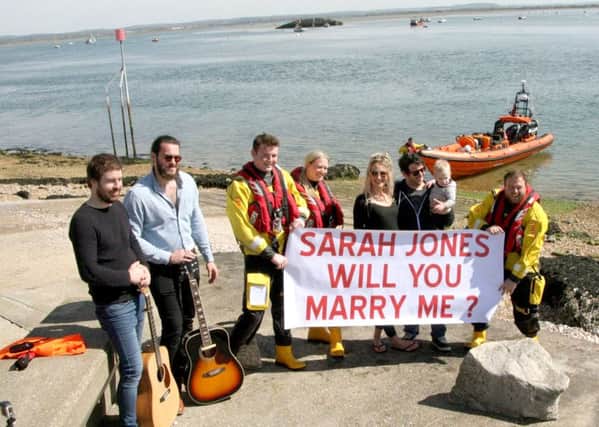 From left, Barry Hardman, Lewis Wright, Harrison Finch from the RNLI, Katie Baker from the RNLI, Sarah Jones with Mark Hummerstone and Shelby, two, Luke Rayner from the RNLI, and holding the boat, Gareth Davies