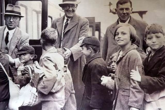 Evacuees boarding a train at Portsmouth & Southsea low level. Children right to left: Ray Emery with sisters Vilma and Marlene. The teachers are left to right: Headmaster Mr Davis, Mr Farrow and Mr Knight