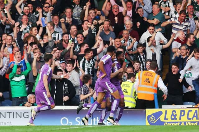 Plymouth fans celebrate one of Jamille Matt's two goals at Fratton Park last night   Picture: Joe Pepler