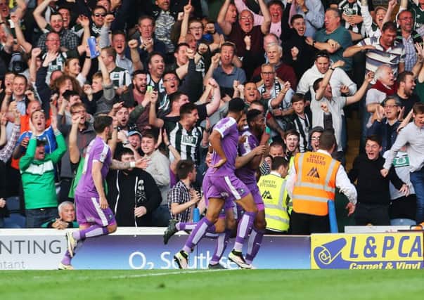 Plymouth fans celebrate one of Jamille Matt's two goals at Fratton Park last night Picture: Joe Pepler