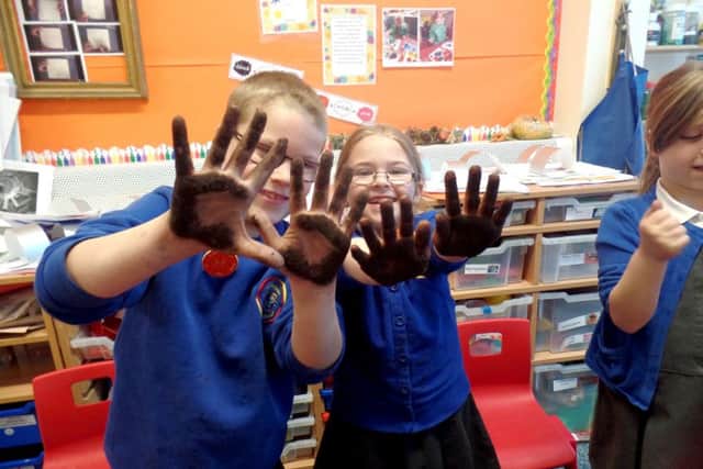 Children at Wallisdean Infants planting the seeds