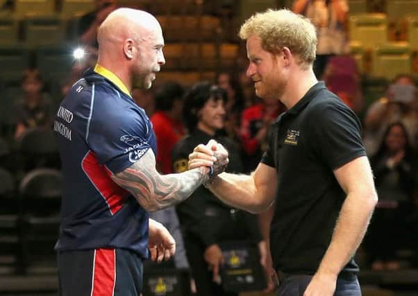 Prince Harry presents Mickey Yule with the powerlifting gold medal during the Invictus Games  Picture: Chris Jackson/PA Wire