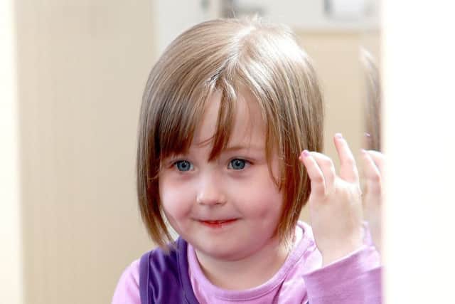 Poppy Hamlyn from Fareham decided to have her hair cut for charity after seeing mum Emma lost hers in her fight against cancer Picture: Darren Ford