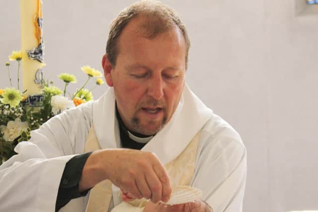 Reverend Jonathan Jeffery performing a baptism