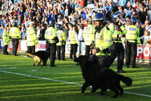 Police dogs were deployed to keep Plymouth fans back at the final whistle Picture: Joe Pepler