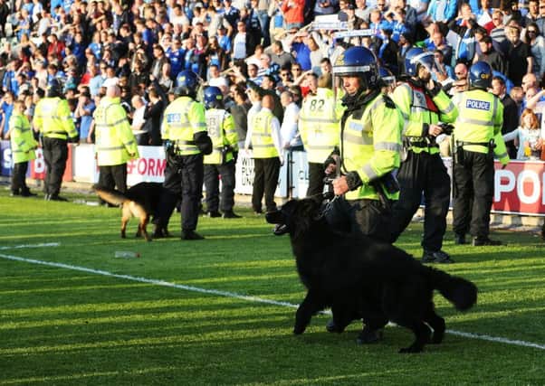 Police dogs were deployed to keep Plymouth fans back at the final whistle Picture: Joe Pepler