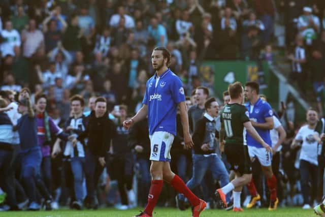 Christian Burgess trudges off as Plymouth fans celebrate their play-off semi-final success. Picture: Joe Pepler