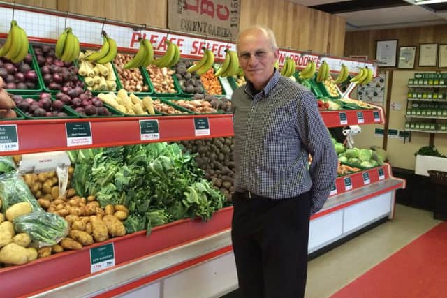 Peter Patterson from All Seasons Fruiterers in High Street Lee-on-the-Solent, in front of the partition that has sparked the disagreement over business rates
Picture: Kimberley Barber