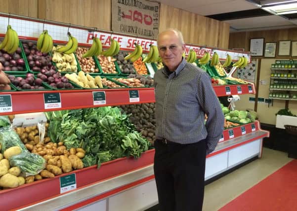 Peter Patterson from All Seasons Fruiterers in High Street Lee-on-the-Solent, in front of the partition that has sparked the disagreement over business rates 


Picture: Kimberley Barber