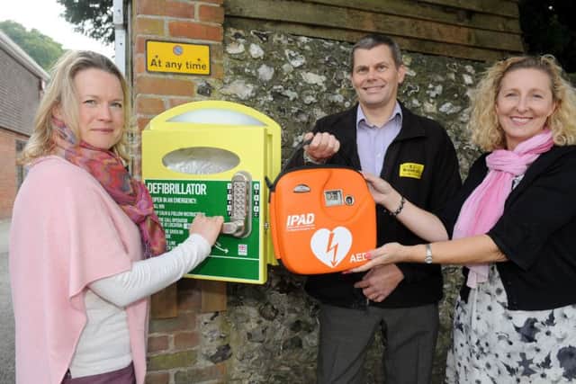 Two defibrillators have been installed in Rowlands Castle following a massive community effort. Pictured is: (l-r) Lisa Walker, clerk at Rowlands Castle Parish Council, Paul Winnicott, who owns the wall where the defibrillator is located and also director of R J Winnicott Ltd and Rowlands Home Hardware and Gill Whatley, admin assistant at Rowlands Castle Parish Council.
Picture: Sarah Standing (151697-6827)