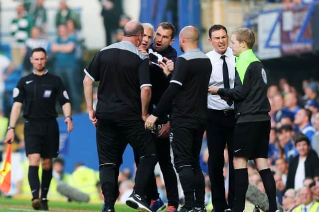 Paul Cook and Plymouth's Paul Wotton square up on the touchline Picture: Joe Pepler