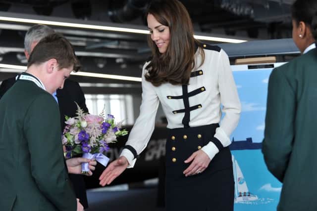 The Duchess of Cambridge is presented with flowers by Oliver Ewins a pupil from St Edmund's Catholic SchoolPicture: Allan Hutchings (160418-616)