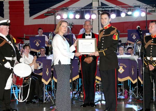 Cdr Sophie Shaughnessy, the Executive Officer of HMS Sultan, with Royal Marine Bugler Kyle Porter and the score of Pedentim, which was written for the 60th anniversary.  Picture: David Berry