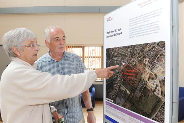 Glenda Edmondson points to her bungalow on the aerial which is opposite the proposed site for homes with Michael Ford who lives in the same road Picture: Sarah Standing (160732-9770)