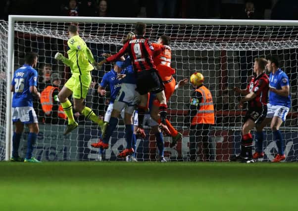 Morecambe keeper Barry Roche heads home a 94th-minute equaliser against Pompey  Picture: Joe Pepler